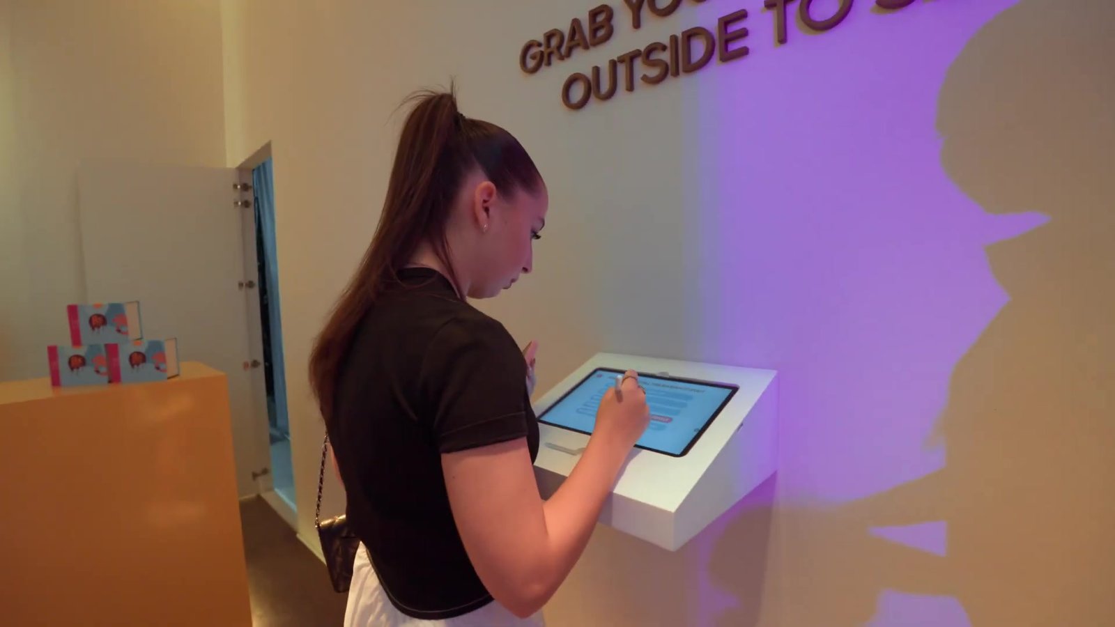 A visitor writing on the FIX event tablet